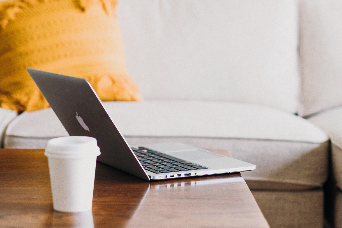 telehealth-macbook-at-home about sharon bang telehealth services: macbook on coffee table with coffee cup at home